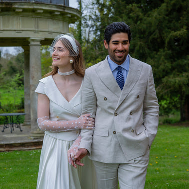 A husband and wife wearing wedding gloves in the park