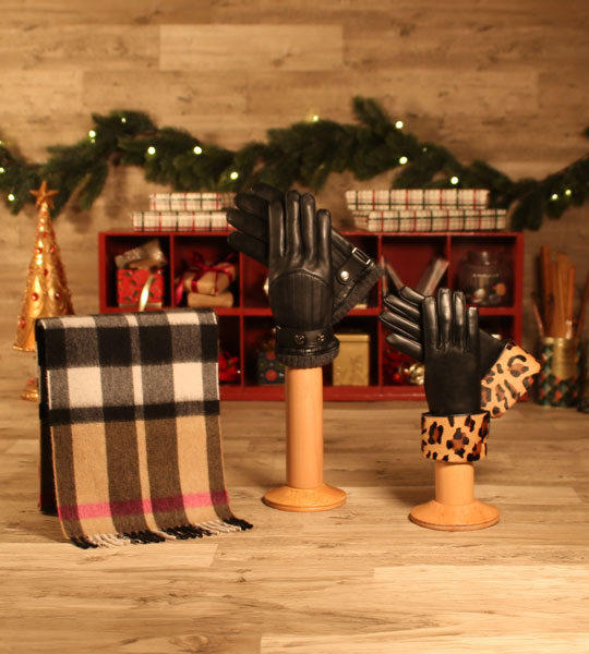 Mens and womens gloves and a scarf in a christmas workshop