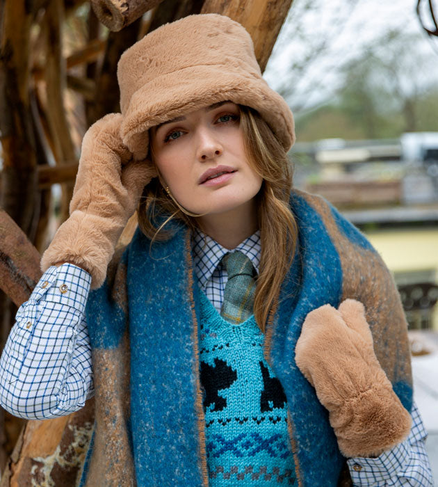 Woman wearing faux fur matching set of hat and mittens